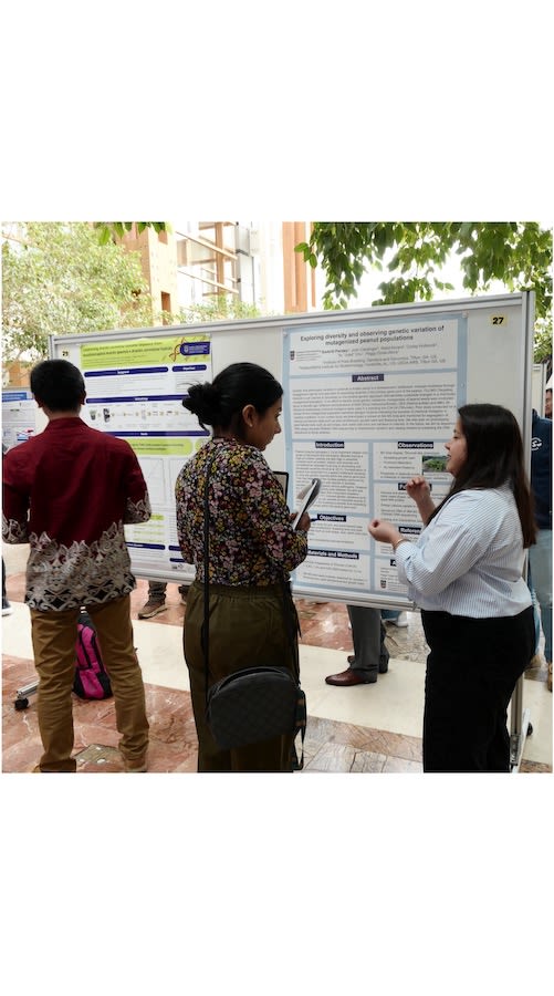 Two women at a scientific poster discussing its contents
