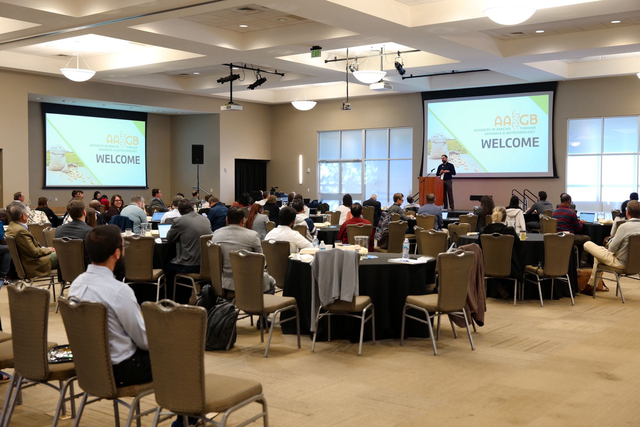 A man at a podium speaking in front of an audience