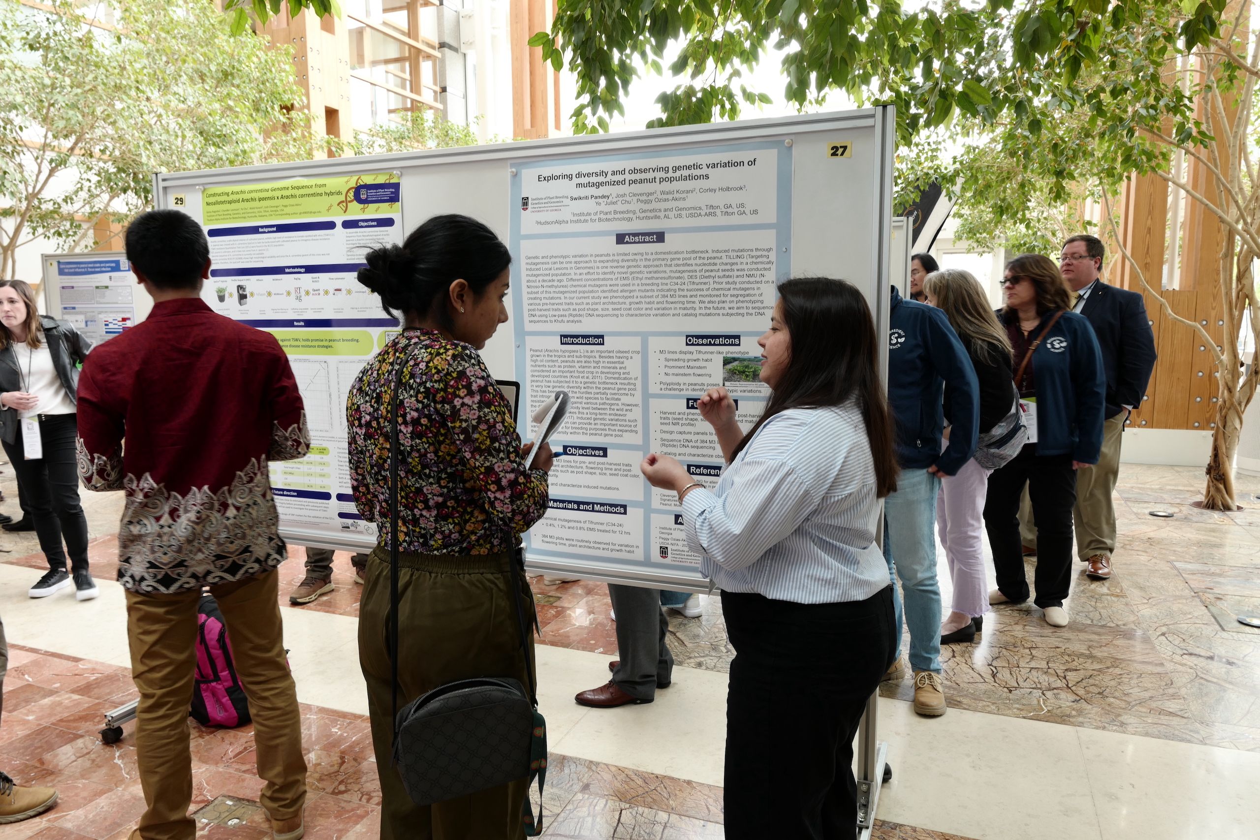 Two women at a scientific poster discussing its contents