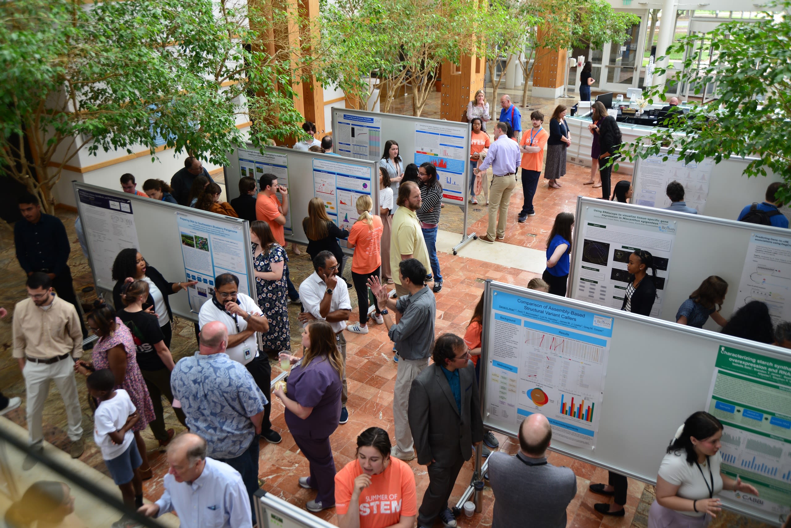A group of people at a scientific poster session 