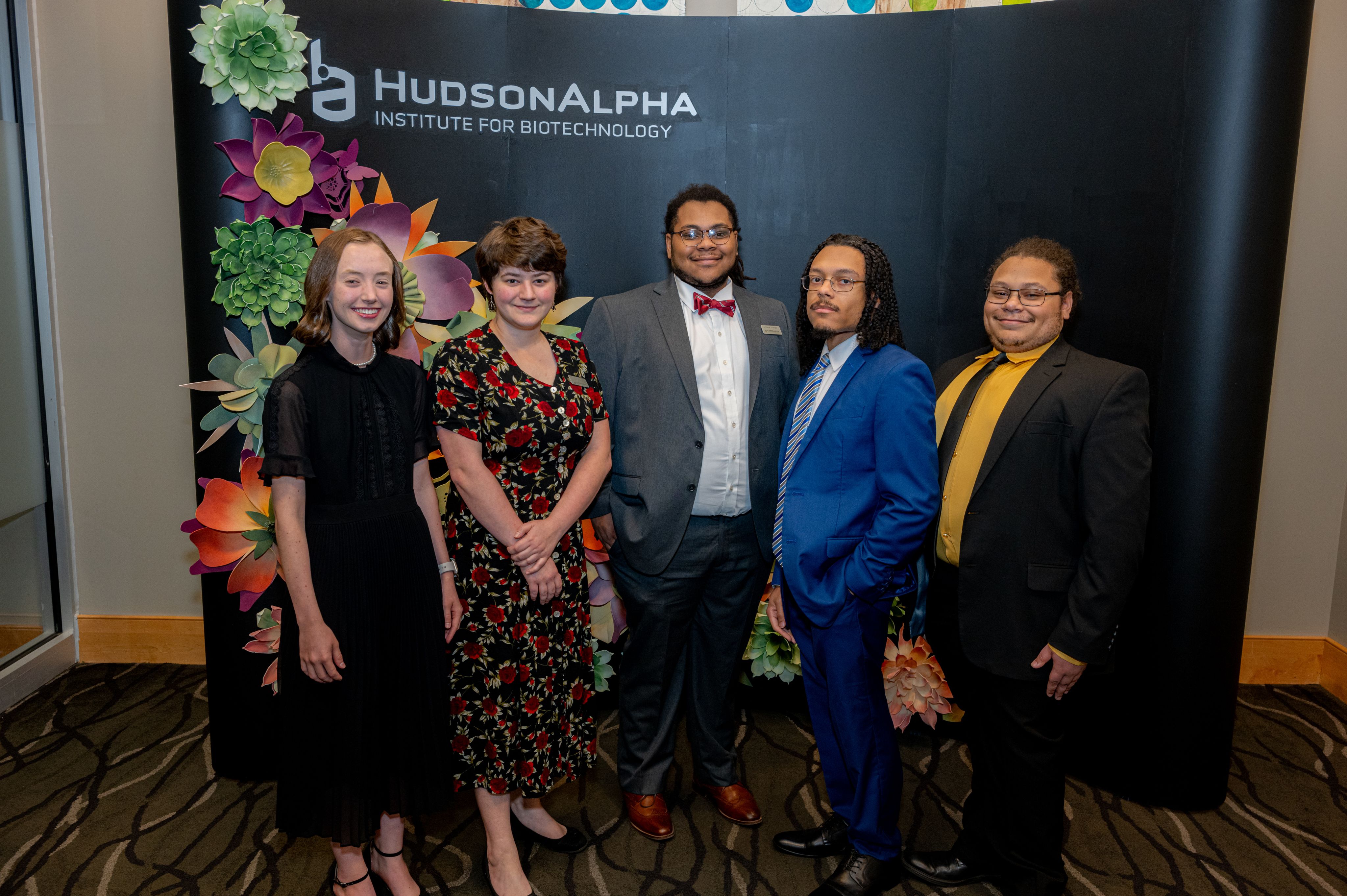 Five young adults dressed up for a benefit gala